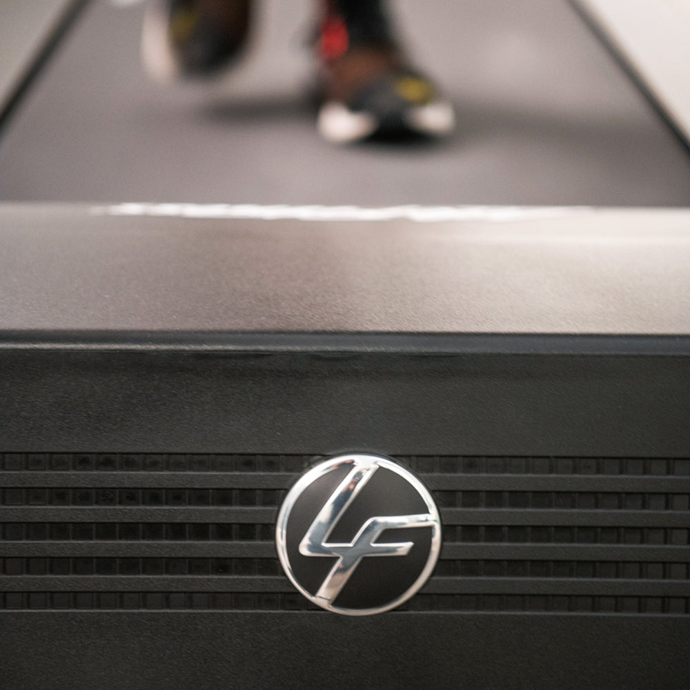 Life Fitness LF logo on front of Run CX treadmill, walking in background