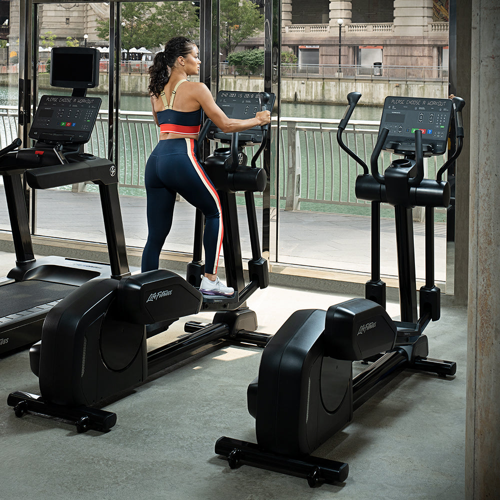 Female exercising on Club Series+ Elliptical in gym