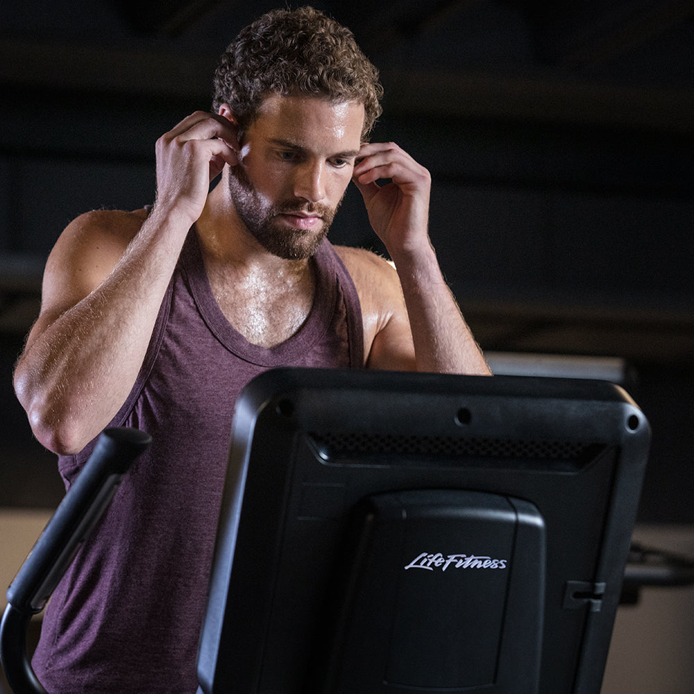 Man exercising on club-quality Life Fitness elliptical