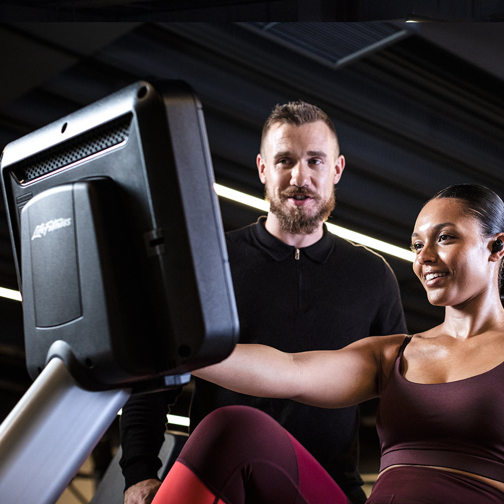 Exerciser interacting with console on Life Fitness bike