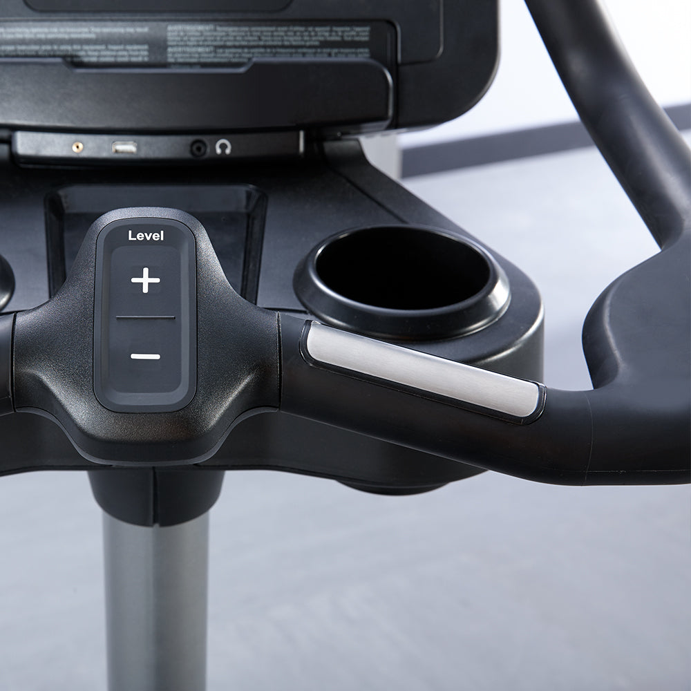 Closeup of handlebars, level adjustment, cupholders on Life Fitness bike