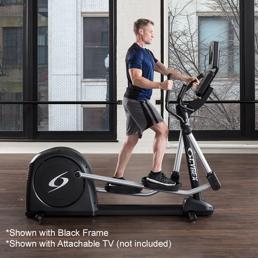 Exerciser working out on Outlet Cybex V Series Elliptical - Shown with Black Frame and attachable TV (not included)