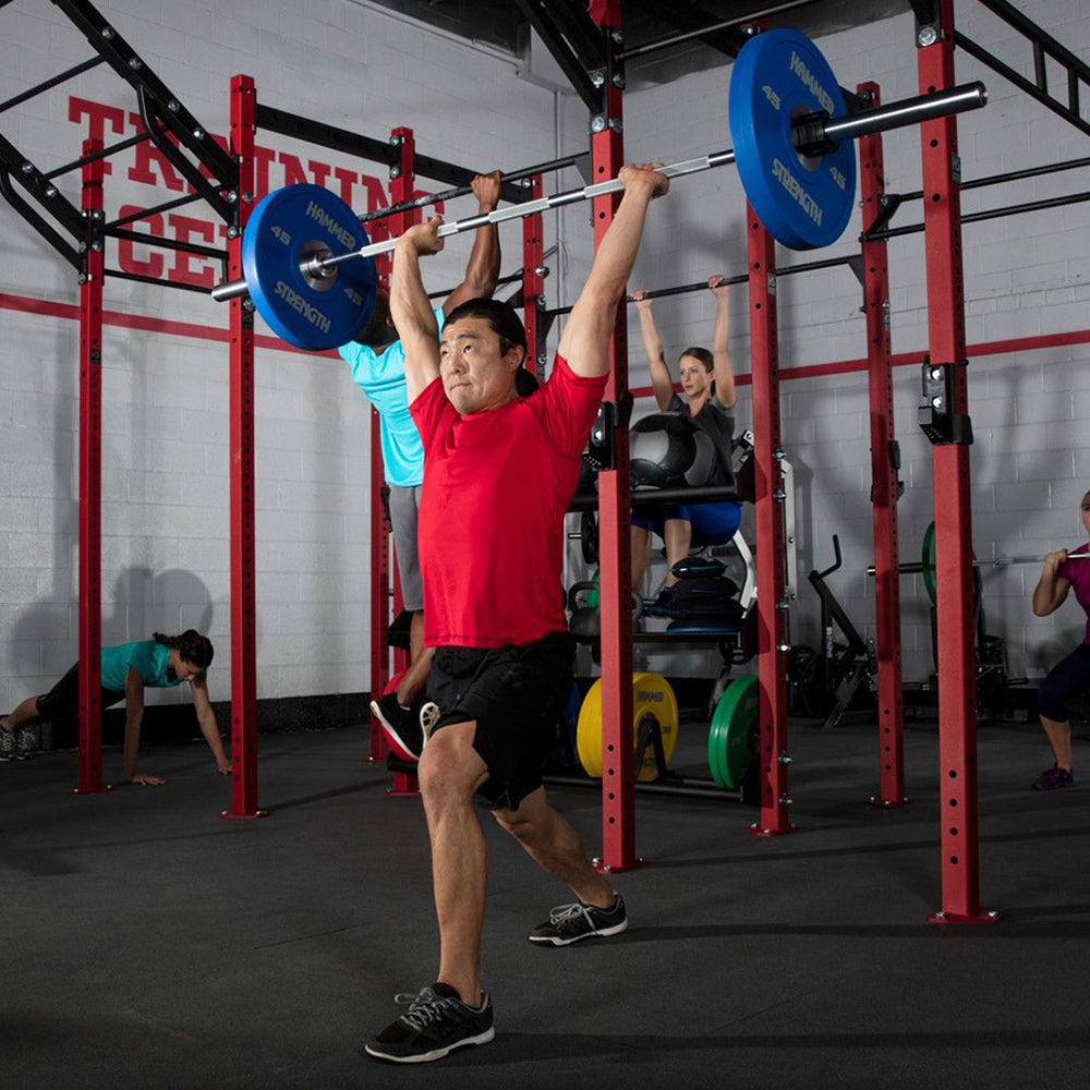 Exercising pressing with Hammer Strength Olympic Weightlifting Bar