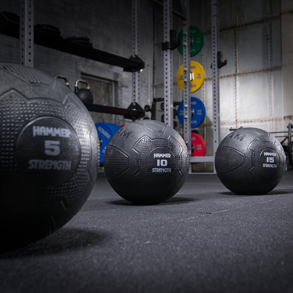 Hammer Strength Slam Balls 5, 10, 15 lbs in a warehouse setting