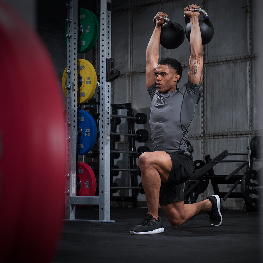 Man overhead pressing Competition Kettlebell