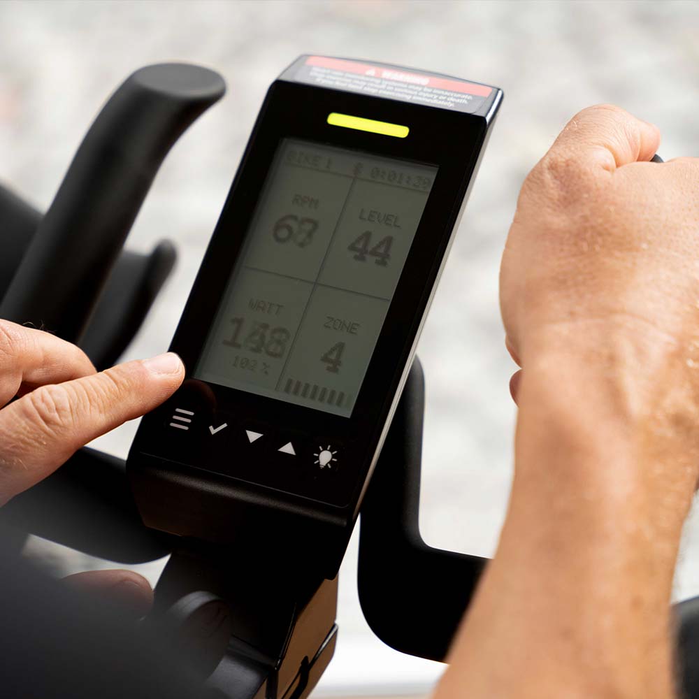 Closeup of IC5 LCD console with exercise data and yellow Coach by Color lit up on