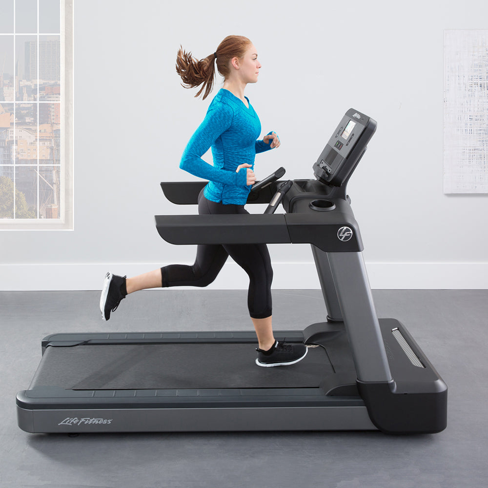 Woman running on Club Series+ Treadmill at home