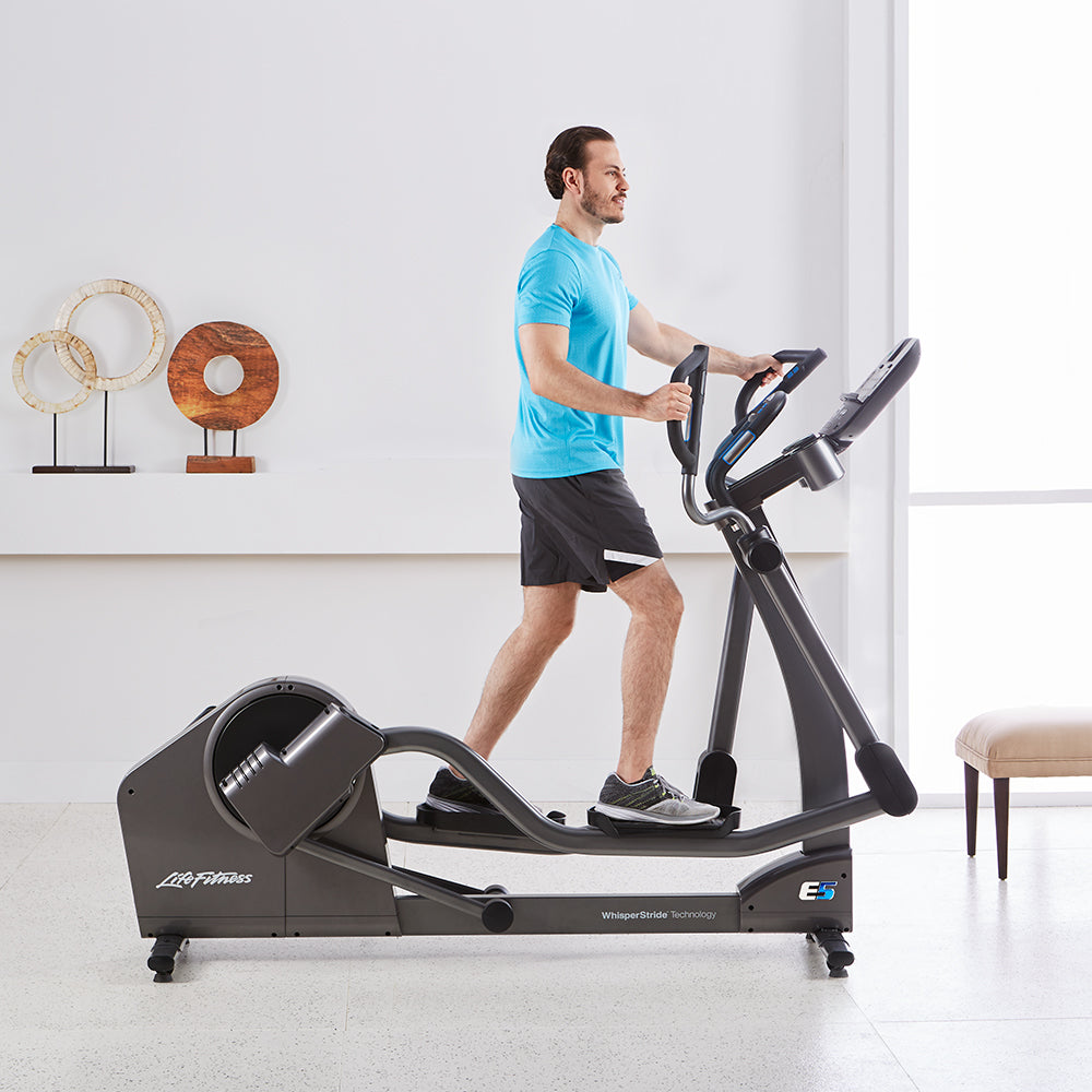 Man exercising at home on E5 Elliptical Cross-Trainer