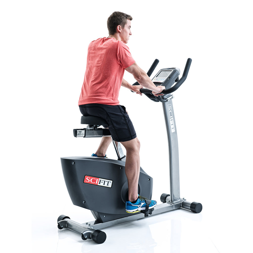 Exerciser pedaling on SciFit upright bike