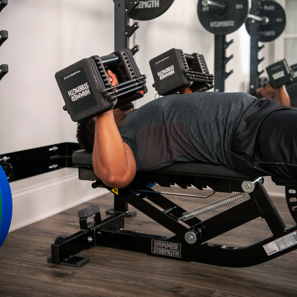 Man bench pressing with Hammer Strength Pro 100s