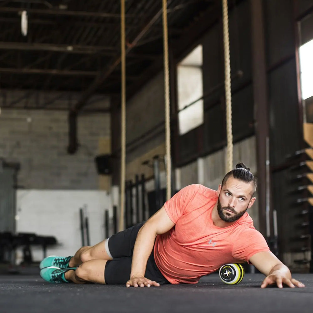 Exerciser using MB5 Massage Ball, rolling out lats