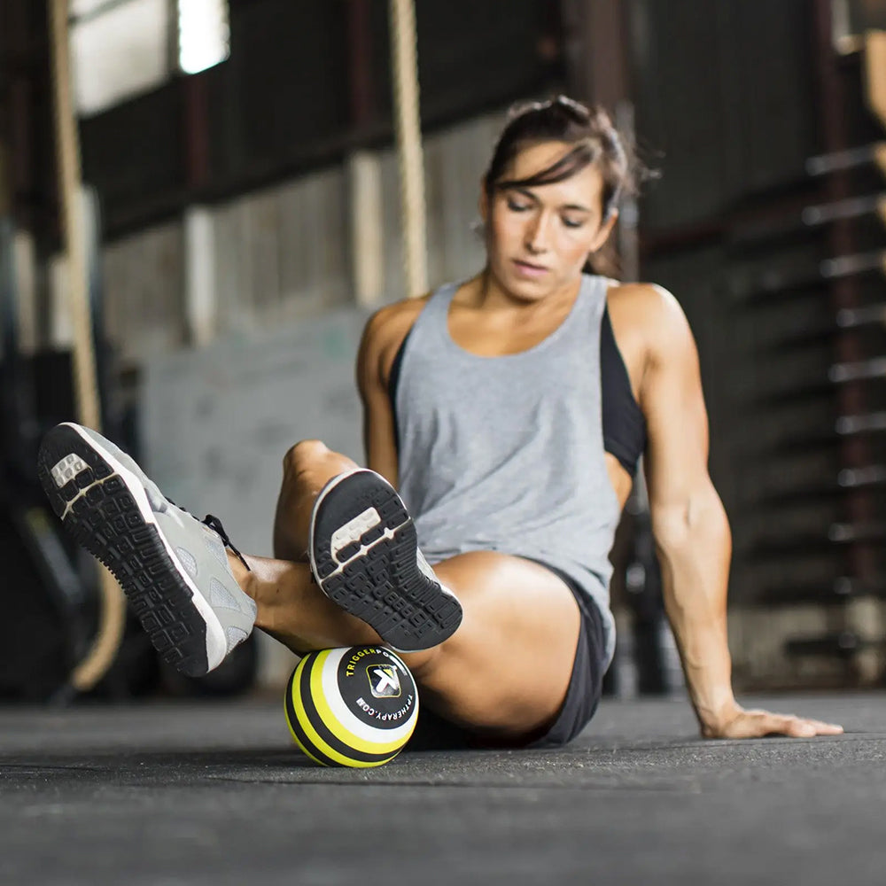 Exerciser using MB5 Massage Ball, rolling out calves